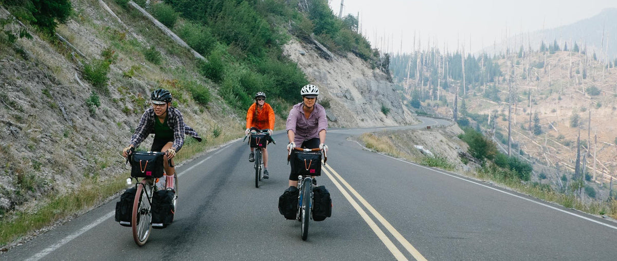 A group of bikepackers on a mountain road